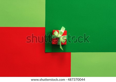 Christmas background of colored paper and a small gift box