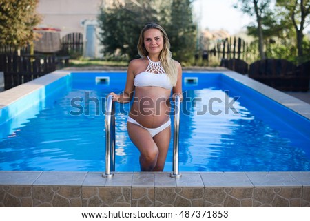 Beautiful pregnant woman in swimming pool