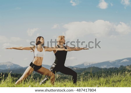 couple of man and woman meditating in yoga in mountain. vintage toned picture
