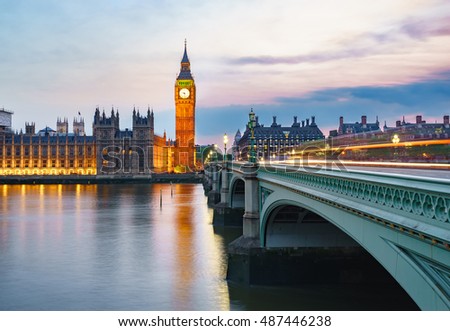 Big Ben viewed from across the River Thames at dusk. Part of Westminster Bridge can be seen