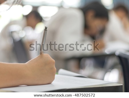 Student's taking exam writing answer in school classroom Royalty-Free Stock Photo #487502572