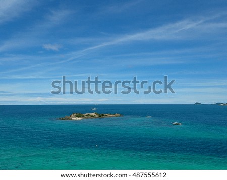 The Island, clear seawater and coral reef on the blue sky in Thailand