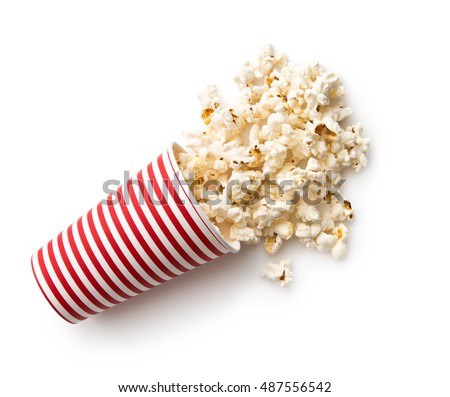 Tasty salted popcorn in striped paper cup isolated on white background. Royalty-Free Stock Photo #487556542