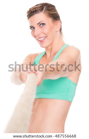 Young and sporty woman in front of white background