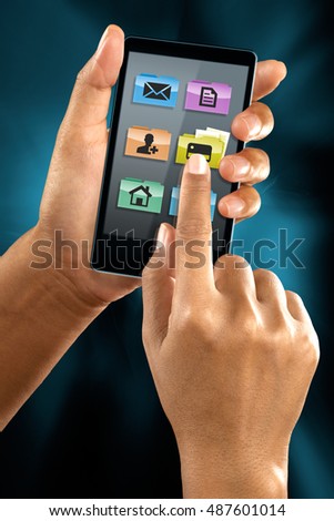 A woman use a mobile phone to select a folder