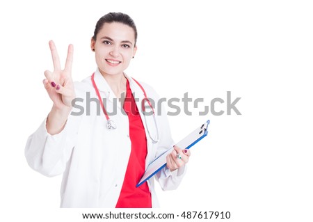 Smiling beautiful doctor doing victory or peace sign on white background with copyspace
