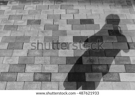 Shadow of tourist photographer on the floor