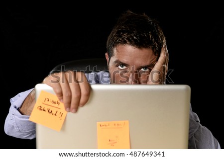 young attractive tired businessman in shirt and tie tired and overwhelmed by heavy work load exhausted at office desk with laptop computer in business stress overwork and overtime concept