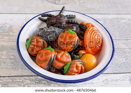 Top view of halloween fruit jelly in bowl on wooden table.