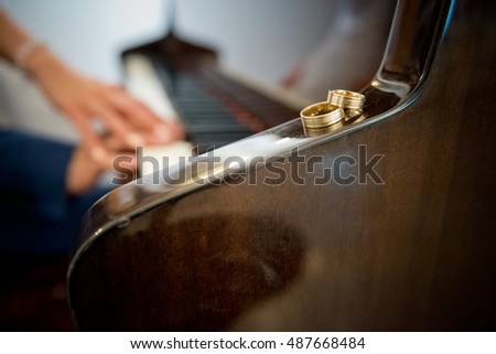Wedding ringswith hands on the piano