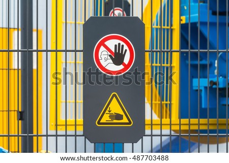 Warning sign for safety on machine, no entry and be careful of hand