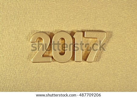 2017 year golden figures on a golden background 