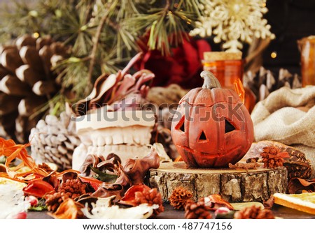 decorative pumpkin for Halloween with dried flowers on a wooden table, selective focus, space for text