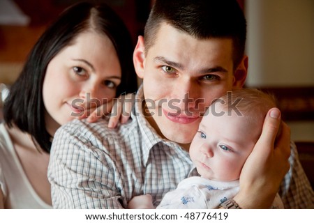Adorable baby, father and mother in home