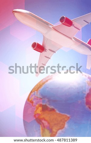 Airplane toy above globe studio shot