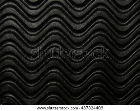 Texture wavy black rubber closeup Royalty-Free Stock Photo #487824409