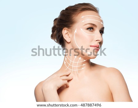beauty, people, plastic surgery, anti-age and health concept - beautiful young woman touching her neck over blue background Royalty-Free Stock Photo #487887496