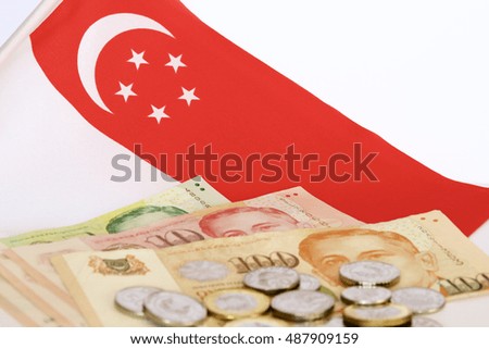 Singaporean flag and money in foreground.