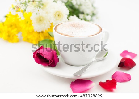 Latte, milk foam and decorated with roses and flowers.