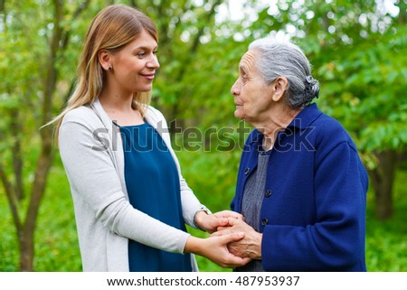  Picture of an old lady taking a walk with her granddaughter