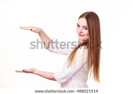Woman showing presenting, long haired fashion girl uses hands to indicate area of frame, copy space for product, graphic, video or text. Presentation, advertisement concept. Studio isolated on white