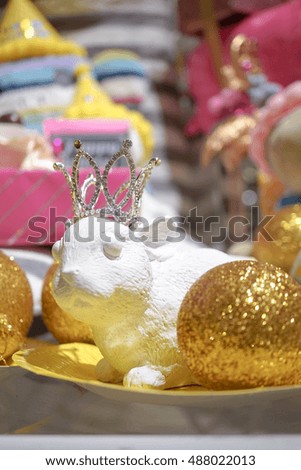DIY birthday decoration on a rabbit (rabbit miniature stone) on display, concept of birthday celebration and birthday decoration for girls (pink and yellow tone) Selective focus on a crown.