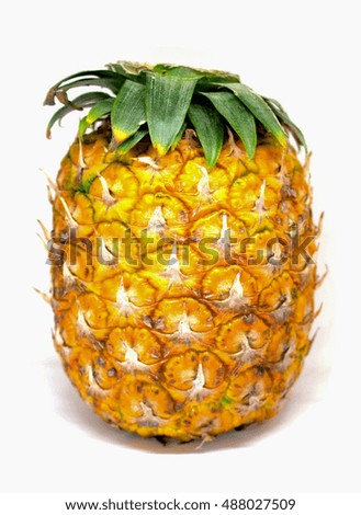 Pineapple with small leaves on top on white background. Yellow ripe exotic fruit for sweet vegetarian dessert. Pine skin surface picture. Tropical garden harvesting. Juicy and fresh pineapple image