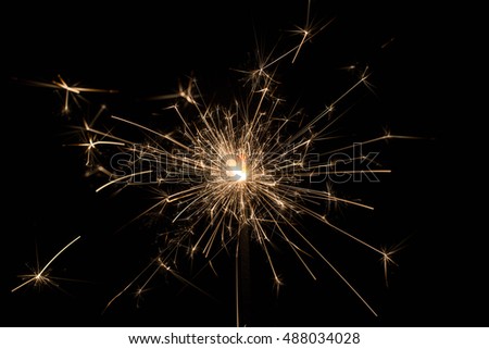Burning sparklers isolated on black background