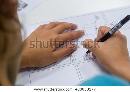 boy drawing on white paper