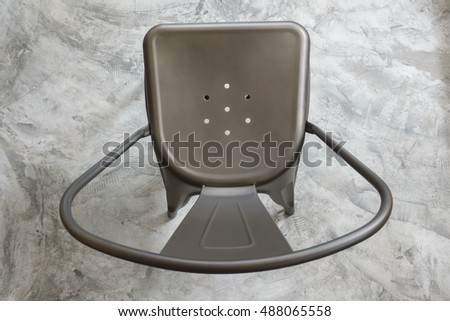 top view of light brown color metal chair on concrete floor Royalty-Free Stock Photo #488065558