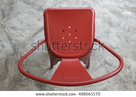 top view of light red color metal chair on concrete floor Royalty-Free Stock Photo #488065570
