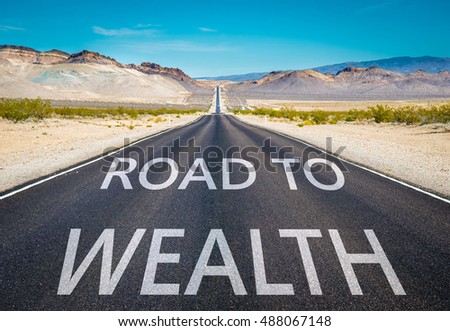 Road to Wealth typed on desert road