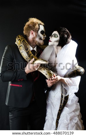 Dead face boy and girl with beautiful snake   