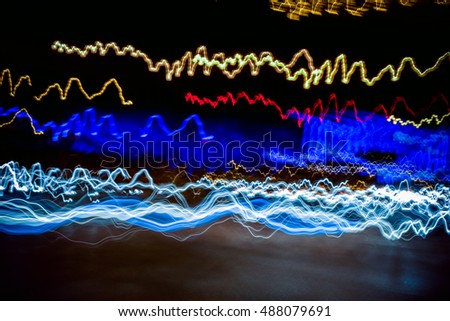 Colorful lights of urban surrounding blurred by motion