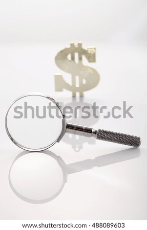 magnifier glass with dollar sign on the white background