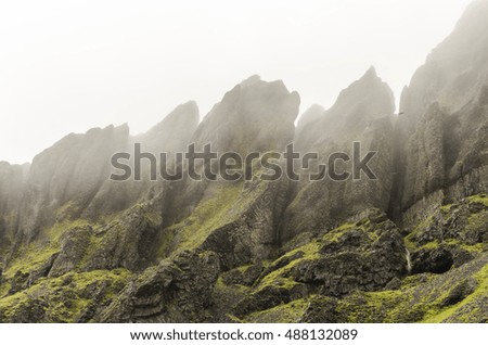 Rocks in fog, south iceland, rainy day in iceland south mountains, dramatic clouds over top of volcanic rocky mountains close to vik