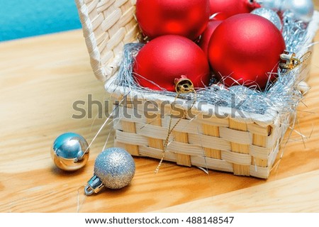 Christmas decorations. Red and gray Christmas balls in a box on the table.
