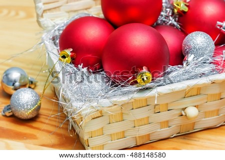 Christmas decorations. Red and gray Christmas balls in a box on the table.