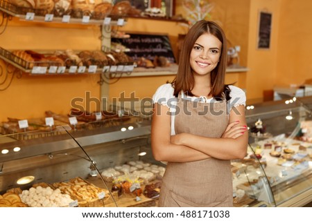 Shot of an attractive cheerful female baker smiling to the camera standing near the showcase copyspace  Royalty-Free Stock Photo #488171038
