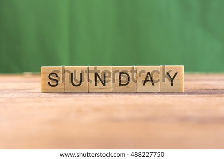 the word of SUNDAY on wood tiles concept