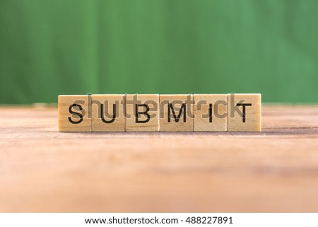 the word of SUBMIT on wood tiles concept