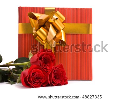 Red roses and gift box on a studio white background