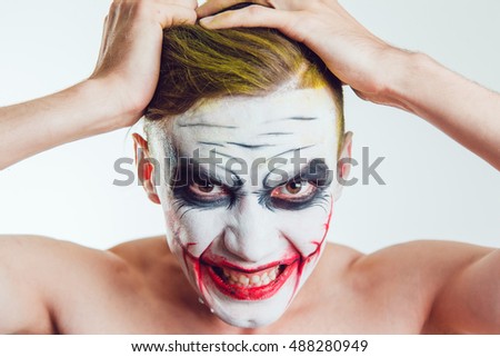 Man with Halloween face art on white background
