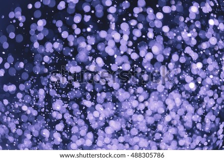 bokeh of water fly and lights on black background. abstract background blue bokeh