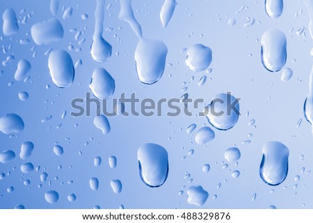 blue rain drops on a window 