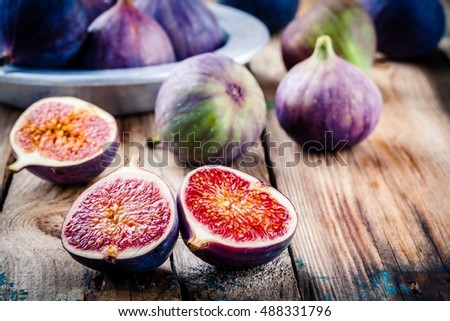 Fresh ripe figs on a wooden background