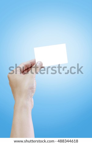 Woman hand holding blank white name card, on blue background