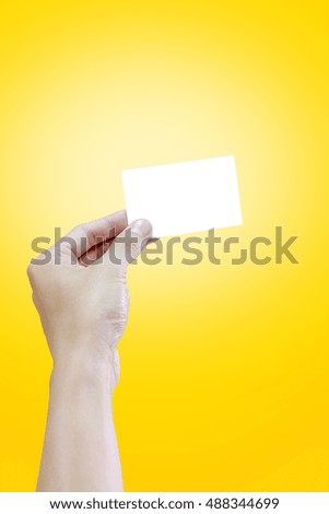 Woman hand holding blank white name card, on yellow background