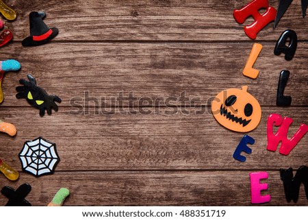 Halloween holiday background with pumpkin and candy. View from above
