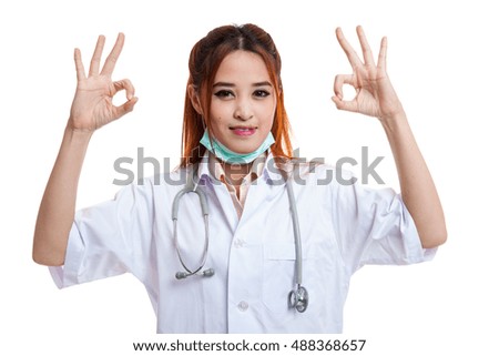 Young Asian female doctor show two OK sign  isolated on white background.